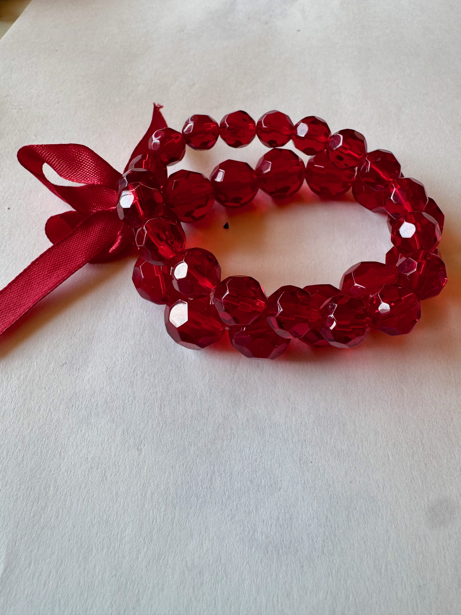 Armband op elastiek met rode facetkralen